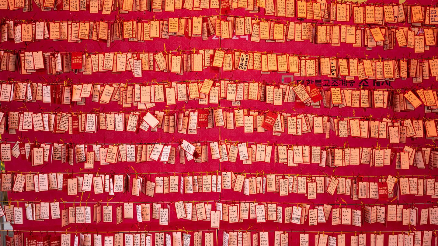Notes with South Korean wishes on a wall in a temple Notes with South Korean wishes on a wall in a temple