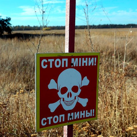 A warning sign "Stop! Mines" in the Kharkiv region, Ukraine
