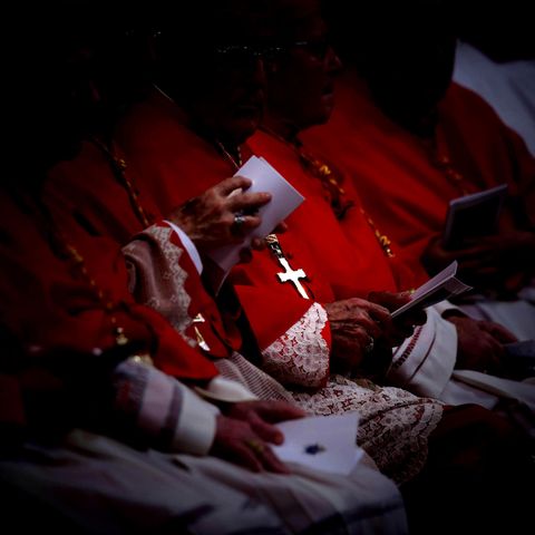 Cardinal with a cross chain around the neck