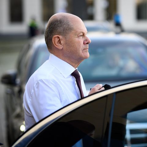 Chancellor Olaf Scholz gets out of a car
