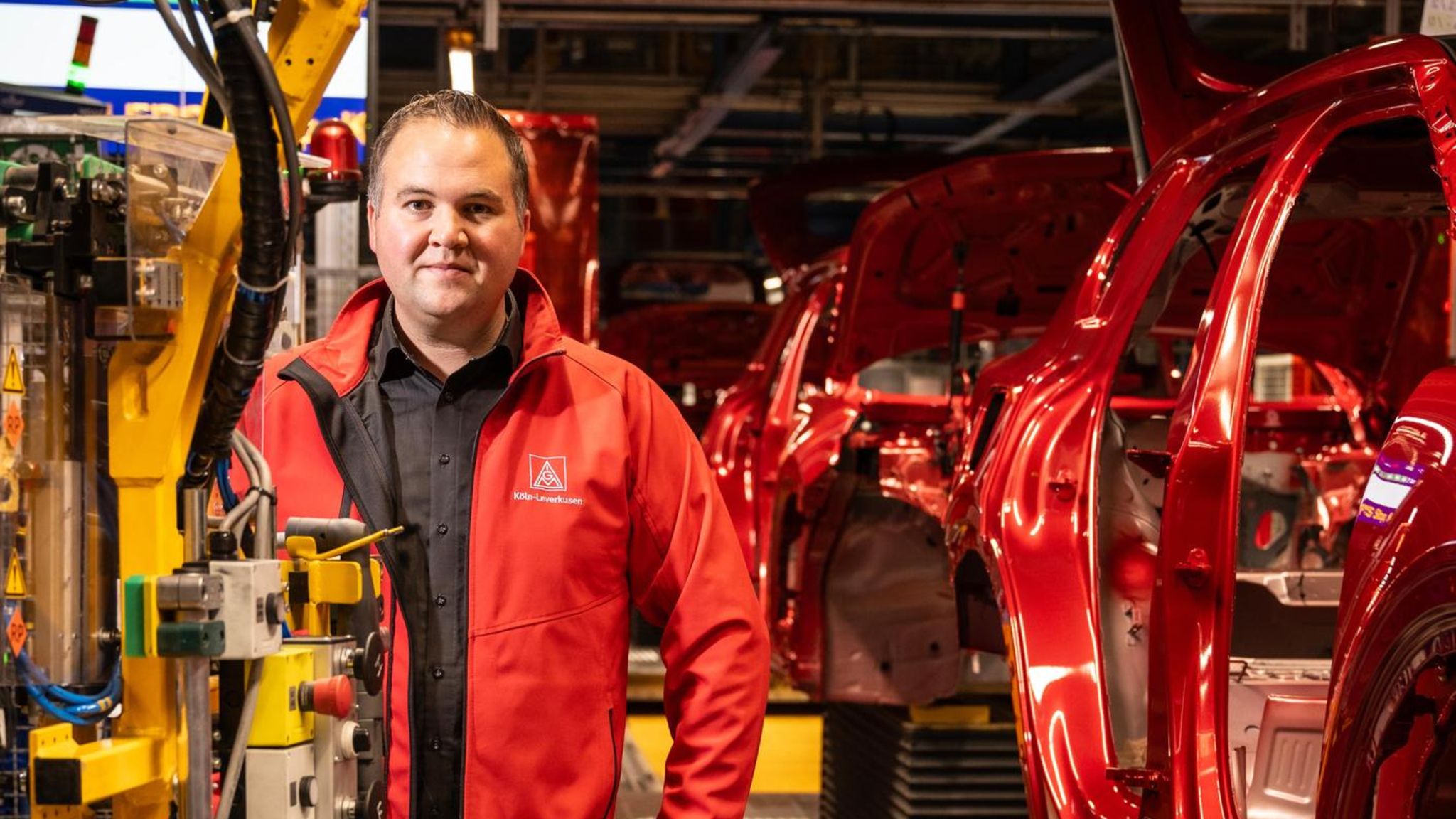 Betriebsrätler David Lüdtke vor dem Fließband in der Ford-Fabrik