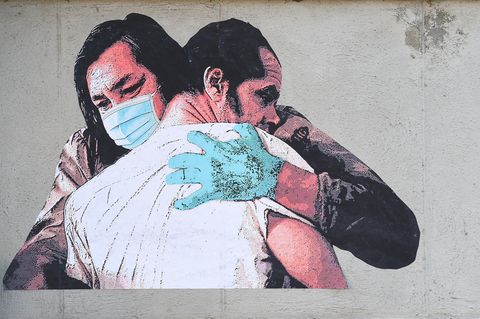 Zwangsbehandlung: Grafiiti auf einer Mauer zeigt zwei Männer, die sich umarmen