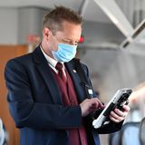 Ein Zugbegleiter der Deutschen Bahn bei der Fahrkartenkontrolle