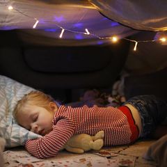 Schnee vor Weihnachten? Ein Mädchen schläft vor seinem Bett