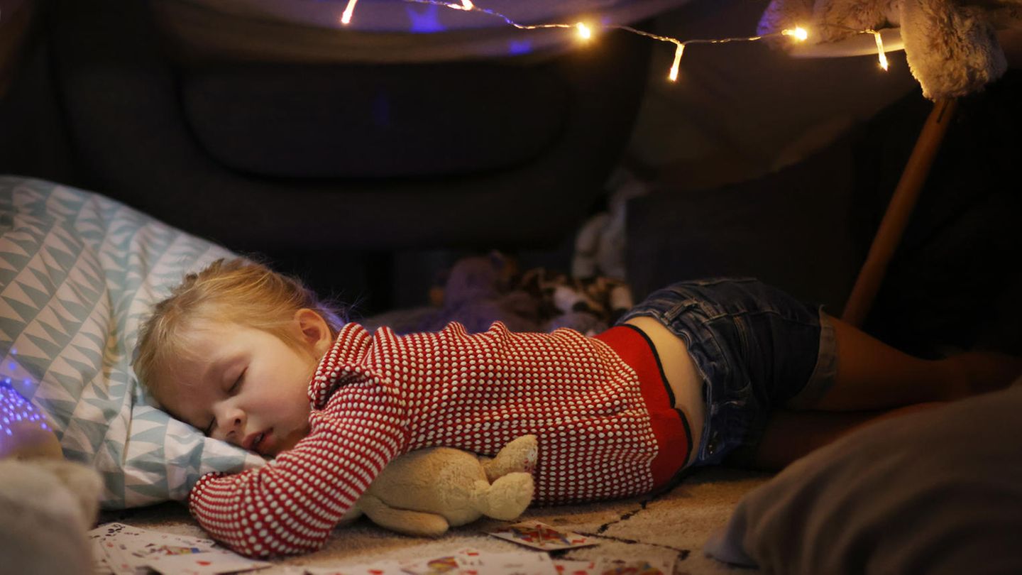 Schnee vor Weihnachten? Ein Mädchen schläft vor seinem Bett