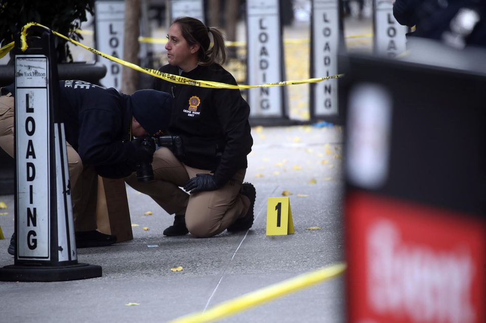 Ermittler fotografieren eine leere Patronenhülse vor dem New Yorker Hotel, in dem Brian Thompson erschossen wurde