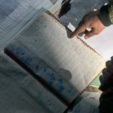 Menschen suchen in den Gefangenen-Listen nach Spuren von Angehörigen