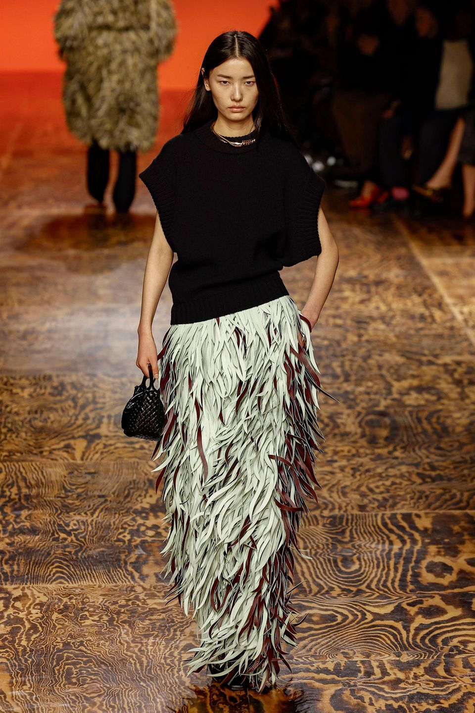 Ein Model trägt ein Lederkleid mit Fransen von Bottega Veneta Ein Model trägt ein Lederkleid mit Fransen von Bottega Veneta