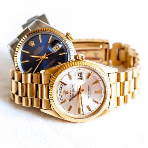 Two Rolex watches are on the table