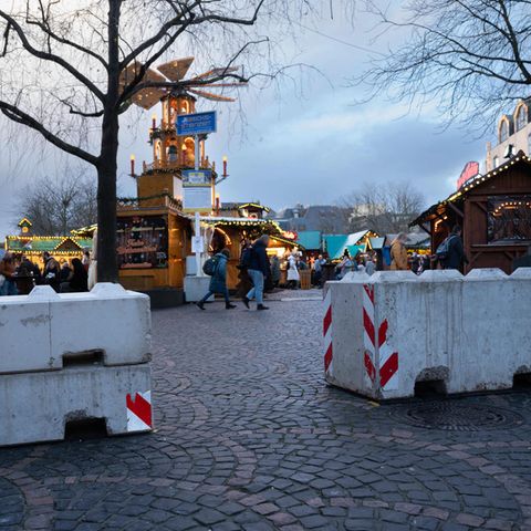 A concrete bollard in front of a Christmas market in Bonn