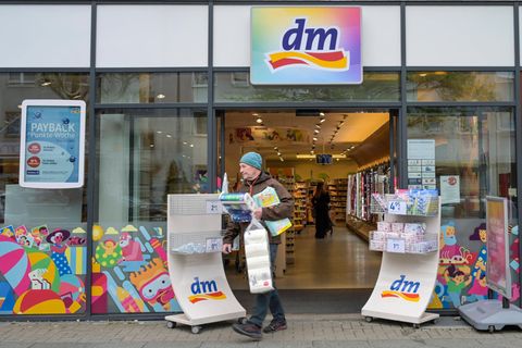 Mann beladen mit Klopapier und Haushaltstüchern verlässt eine dm-Filiale in Berlin Zehlendorf, Medikamente hat er nicht gekauft