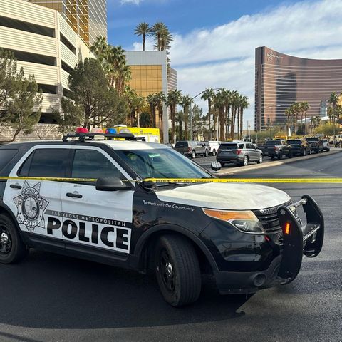 A police car cordons off the area in front of a Trump hotel in Las Vegas