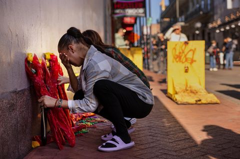 Trauernde Frauen legen Blumen für die Opfer nieder