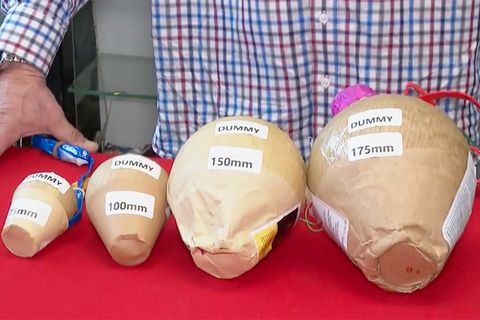 Ein Experte zeigt vier Kugelbomben in einem Erklävideo