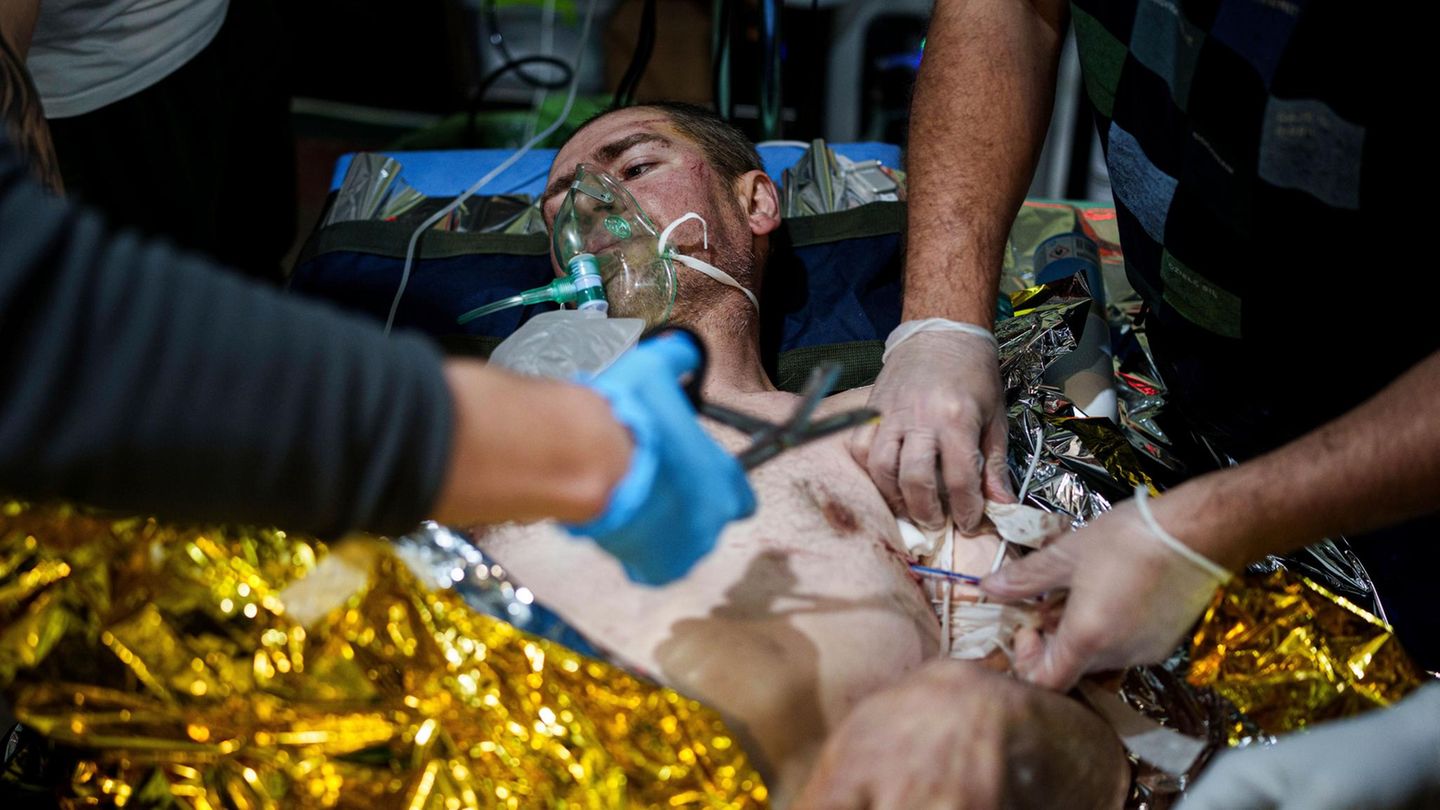 Sanitäter im Kriegseinsatz in der Ukraine behandeln einen Patienten