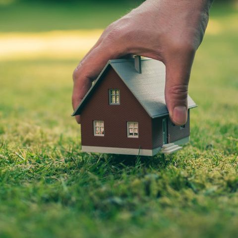 Real estate in hand in meadow