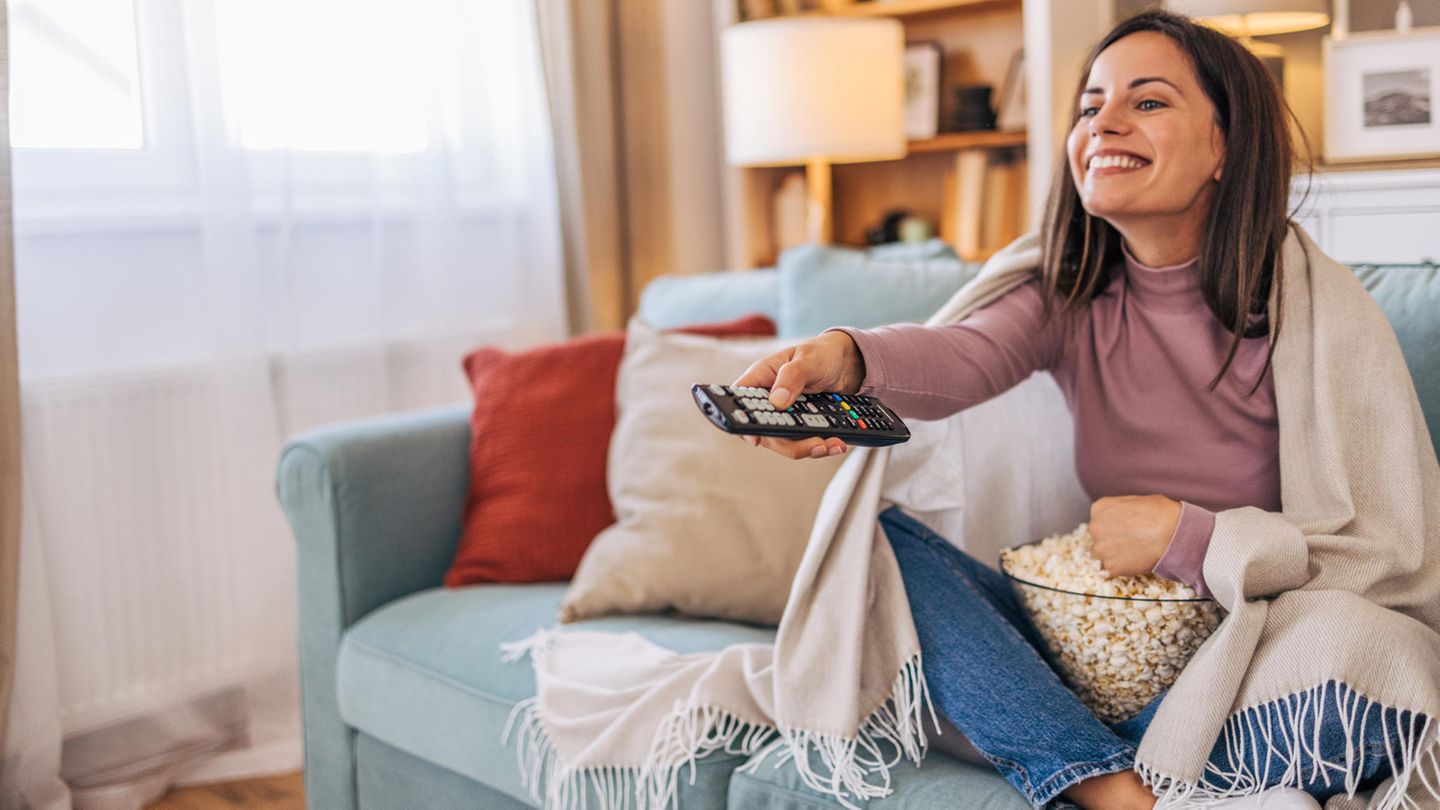 Frau schaut Fernsehen mit HD+