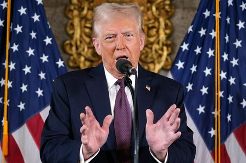 Der designierte US-Präsident Donald Trump spricht auf einer Pressekonferenz in ein Mikrofon