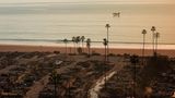 Nichts als Zerstörung: Bis an den Pazifik sind die Häuser in Pacific Palisades, einem Stadtteil von Los Angeles, am Donnerstag niedergebrannt. Im Hintergrund füllt ein Löschflugzeug seine Wassertanks im Meer auf