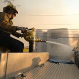 Am Boden versucht dieser Feuerwehrmann, das Übergreifen des Feuers von einem Haus auf das andere in Pacific Palisades zu verhindern