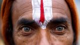 Nahaufnahme der Augen eines Teilnehmers mit einem auf die Stirn gemalten Zeichen