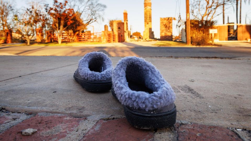 There are slippers in an abandoned driveway