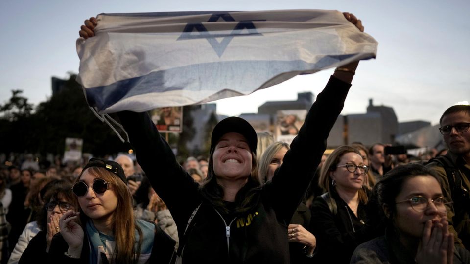 The Israelis celebrate when it is announced that the three hostages are safe