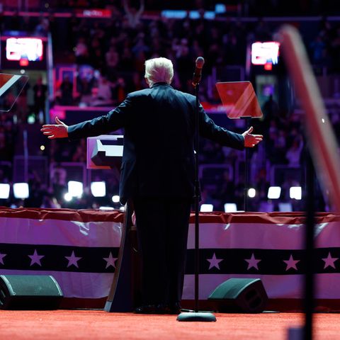 The Almighty? Donald Trump appears at the Capital One Arena in Washington after his inauguration