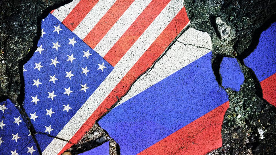 Kreml-Experte zu Trumps Zolldrohungen: "Das wird Russland nicht wirklich wehtun" Eine US-amerikanische und russische Flagge sind auf Stein gemalt und in Stücken aneinander gelegt