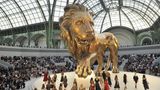 Im Pariser Grand Palais steht ein großer goldener Löwe auf dem Laufsteg