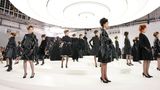 Chanel-Models in schwarzen Kleidern auf einem weißen, runden Laufsteg