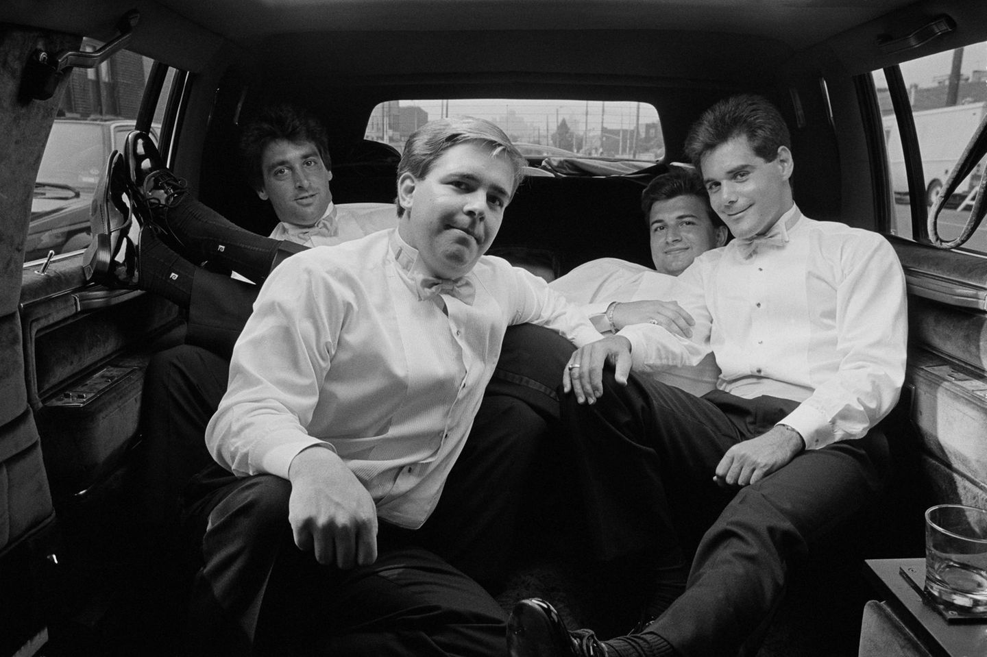 Eine Gruppe Männer in Anzügen auf der Rückbank