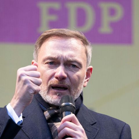 FDP top candidate Christian Lindner balls the fist on a campaign stage while talking