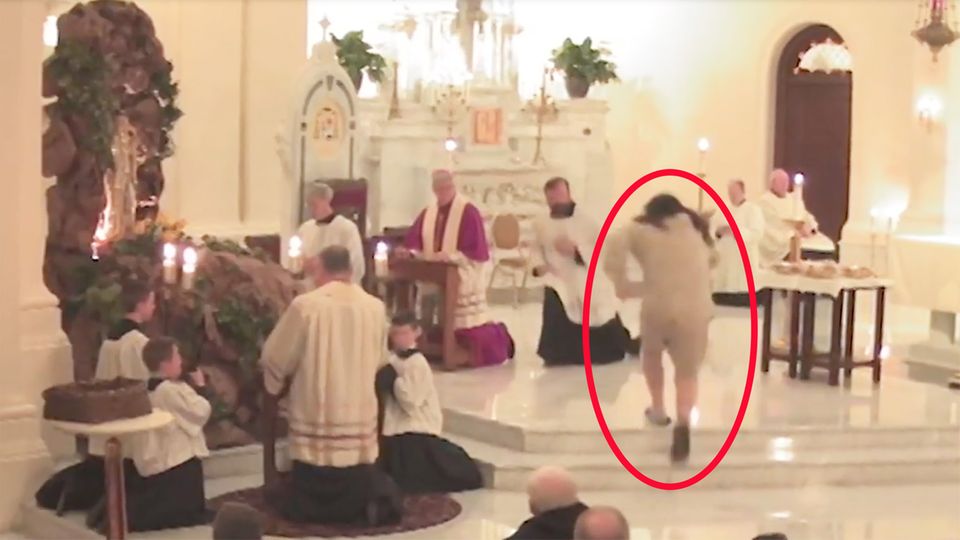 Ein Mann greift in einer Kirche einen der Priester an und reißt diesen zu Boden