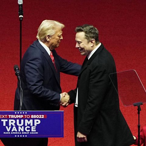 US President Donald Trump and Tesla boss Elon Musk shake hands