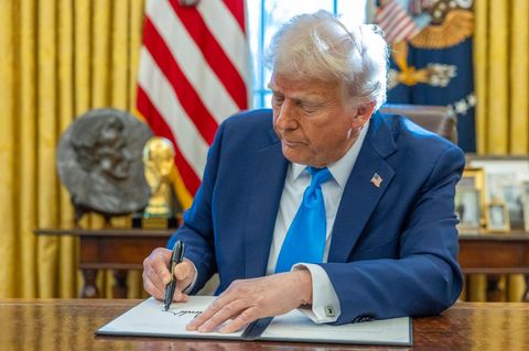 Donald Trump unterschreibt etwas im Weißen Haus