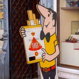 Ein Aufsteller des HB Männchens "Bruno", der eine übergroße Schachtel HB-Zigaretten in seinen Armen hält