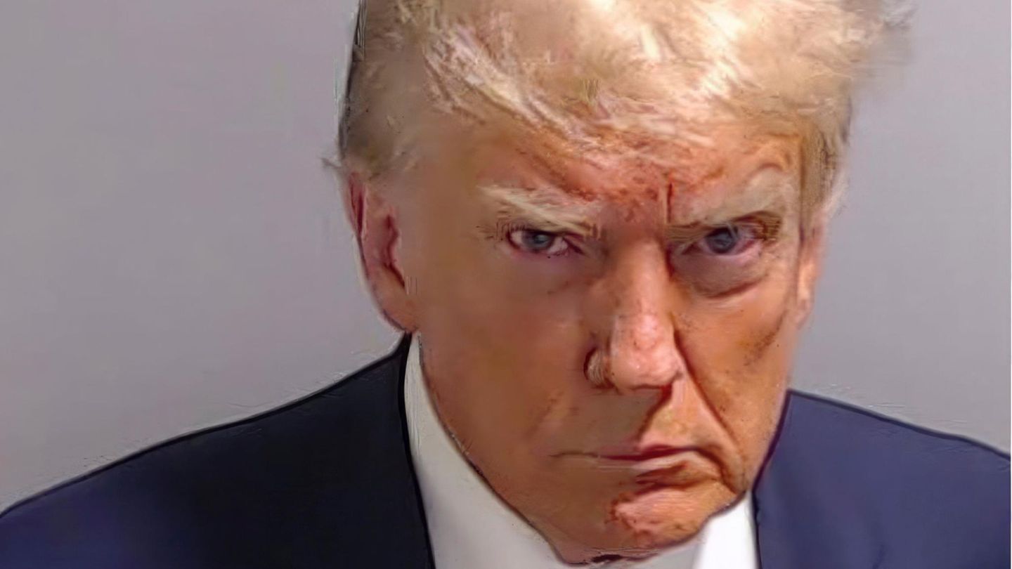 Donald Trump’s Mugshot hangs framed in front of the Oval Office