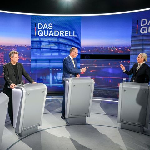 Scholz, Habeck, Merz und Weidel, drei Männer und eine Frau, stehen beim Quadrell hinter Rednerpulten im Fernsehstudio