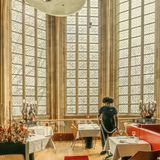 Ein Mann staubsaugt im Speisesaal.