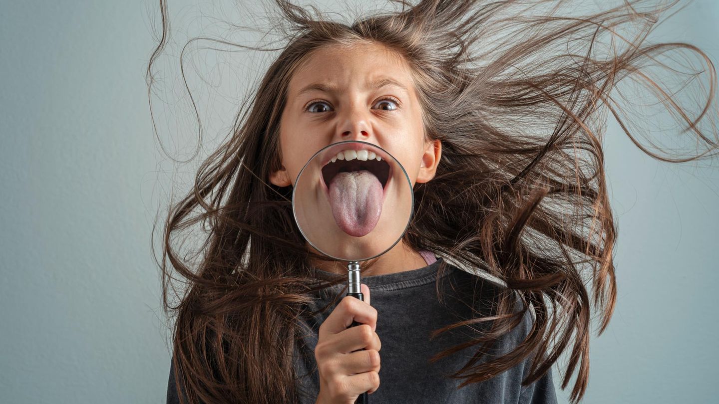 Mädchen mit Lupe vor der Zunge Mädchen mit Lupe vor der Zunge