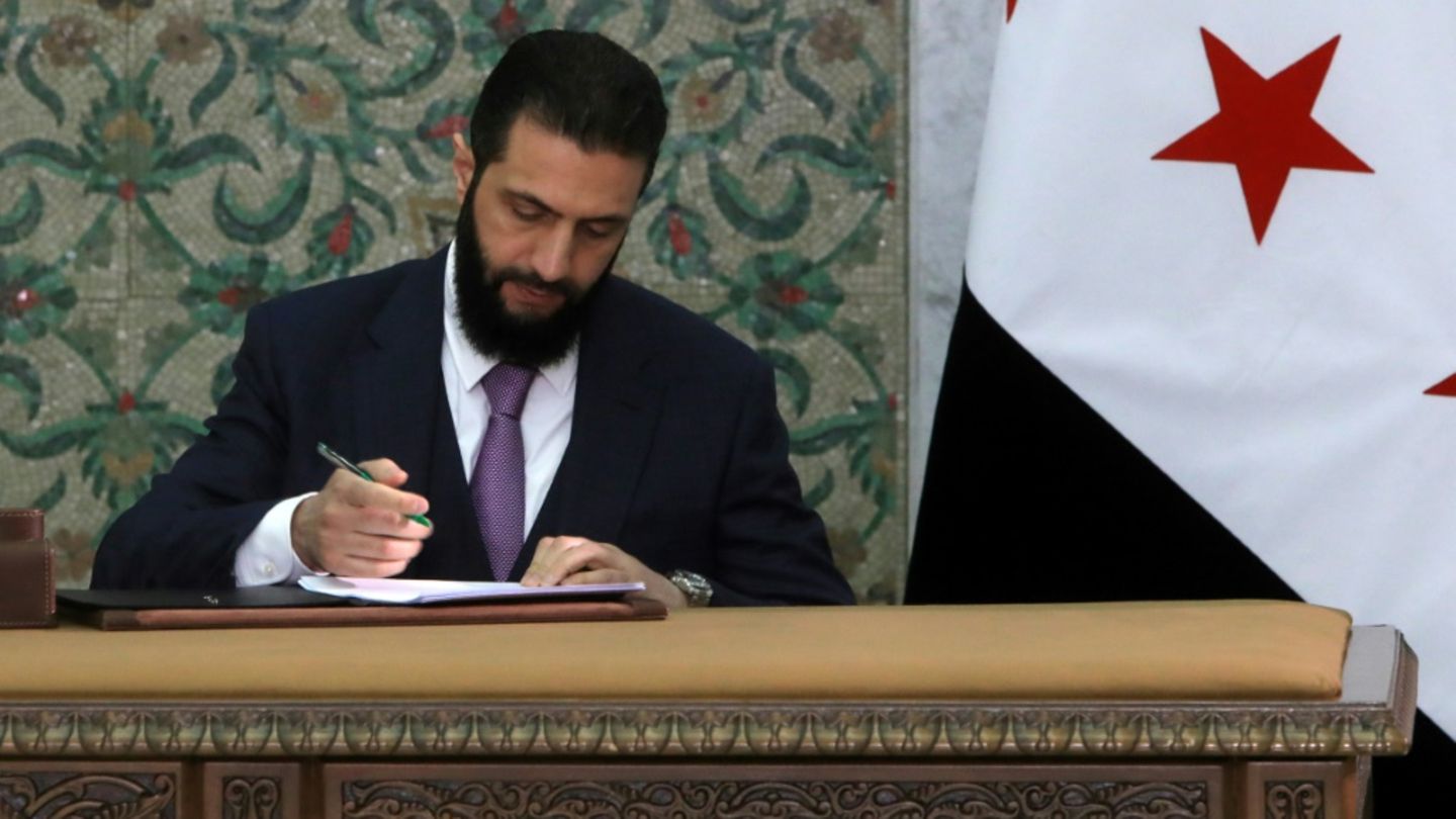 Syriens Übergangspräsident Ahmed al-Scharaa bei der Unterzeichnung der Verfassungserklärung