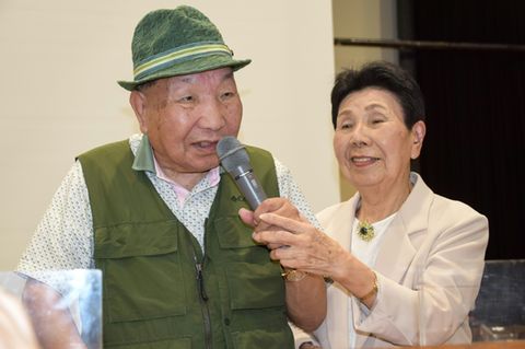 This photo taken in September 2024 shows Iwao Hakamada (L) speaking as his 91-year-old sister Hideko holds the microphone