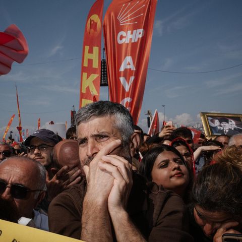 Skeptically showing demonstrator at rally in Turkey