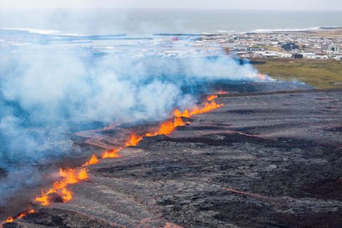 Lava kommt nahe Grindavik aus einem Riss aus der Erde