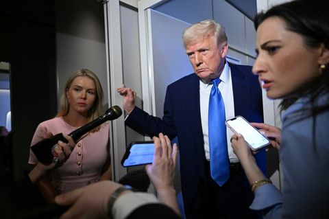 US President Donald Trump speaks to reporters while in flight on Air Force One, en route to Joint Base Andrews on April 6, 2025.