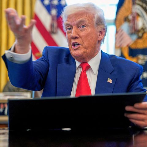 Donald Trump speaks at the desk