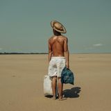 Ein Mann steht auf kilometerweitem, trockenem Flussgrun