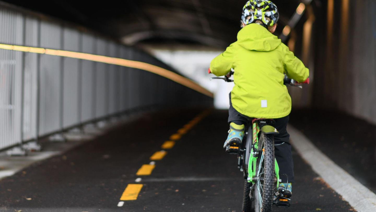 Child cycling on cycling lane in a small European city