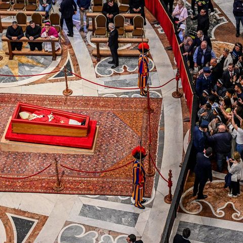 Eine Menschentraube steht vor dem aufgebahrten Papst Franziskus, manche machen Fotos